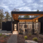 The entry path to Fermata, lined with steel screens on either side.