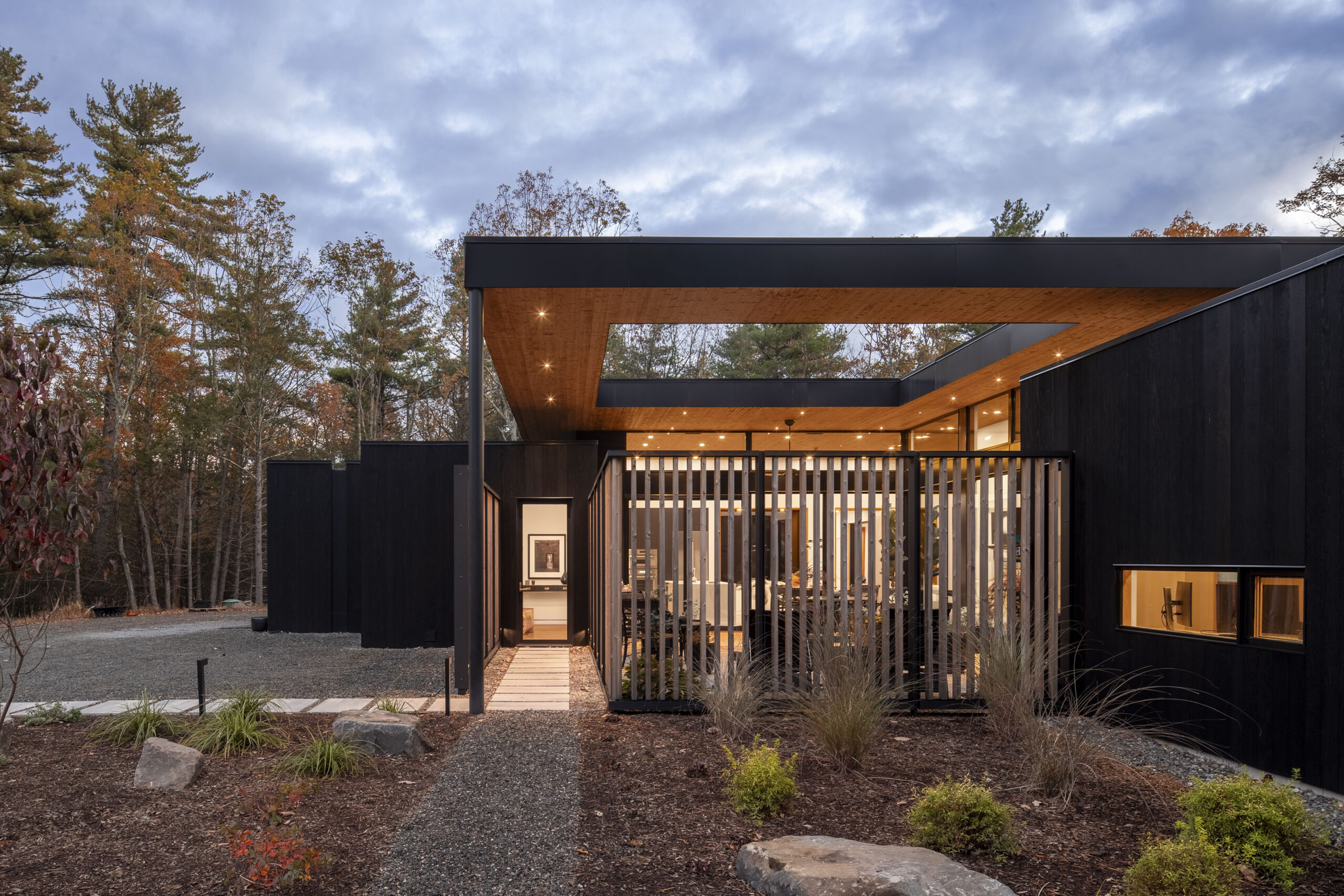 The entry path to Fermata, lined with steel screens on either side.