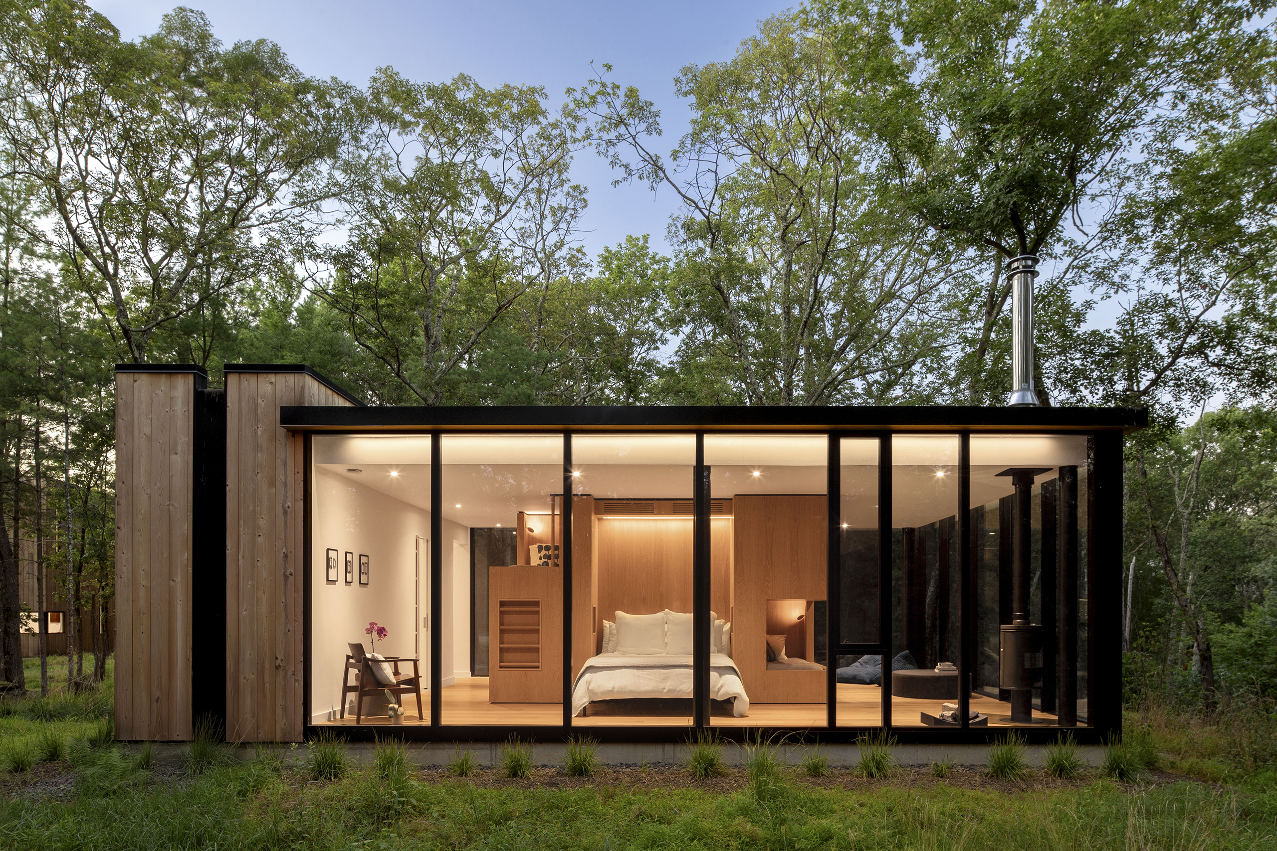 VIA43 Bunkhouse is a glass guesthouse with a central bunk volume for visitors