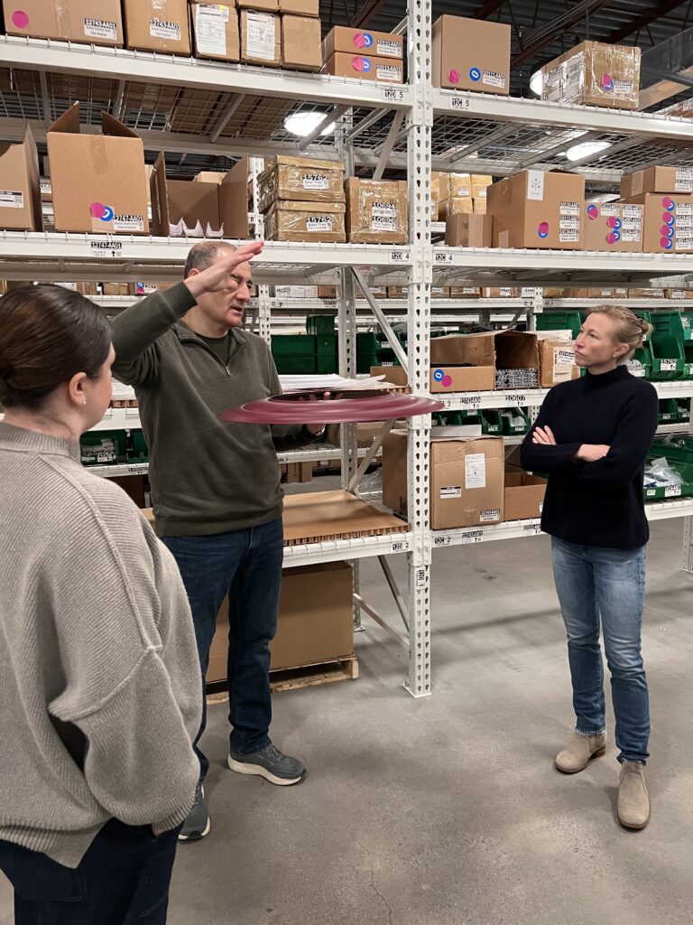 Marica McKeel and the Studio MM team during a factory tour at RBW in Kingston, NY, discussing lighting design and local craftsmanship with a manufacturer.