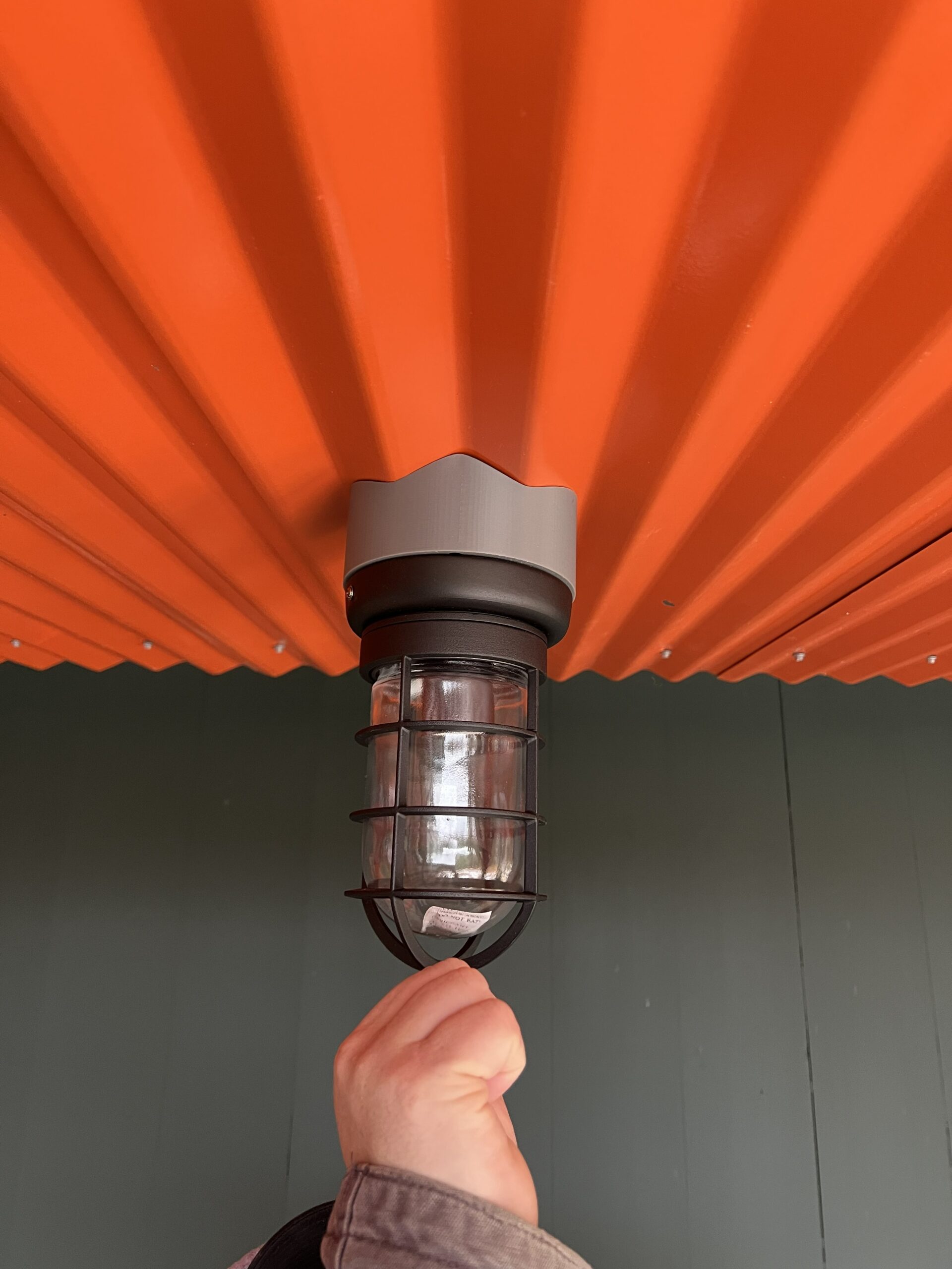 Lighting mounts were custom fabricated to fit the corrugated ceiling at the entry.