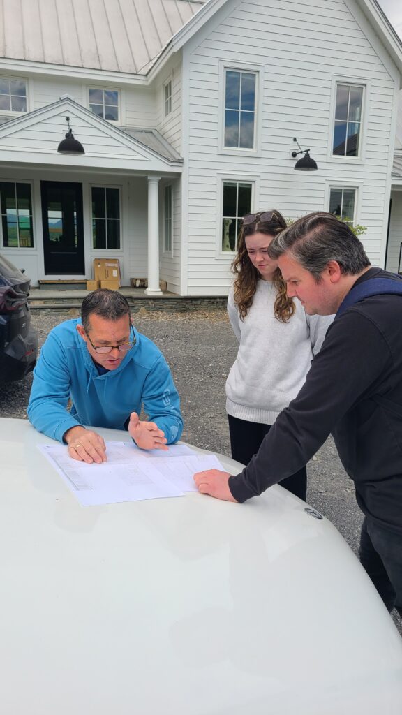 On-site meeting at Queensbury Reno with general contractor, reviewing existing conditions and discussing permit submission requirements.