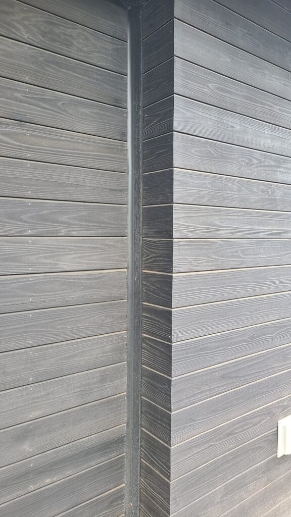 Siding is nearing completion at Artists' Ranch, with rich materials and careful craftsmanship evident throughout the exterior spaces.