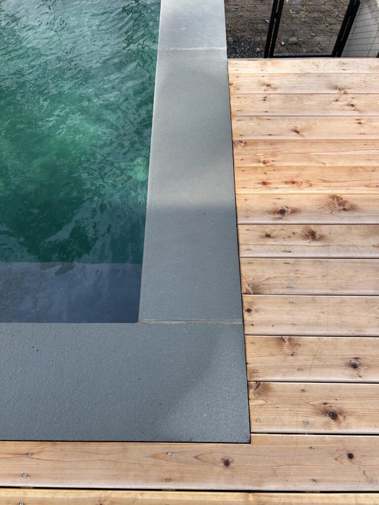 Pool detail at Vannstrom showing the quality of the finished plastering and tile work, with the surrounding deck and railing complete.