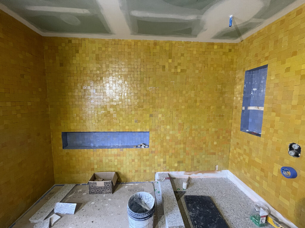 Construction progress at Artists' Ranch showing tile finishes in the main bathroom.