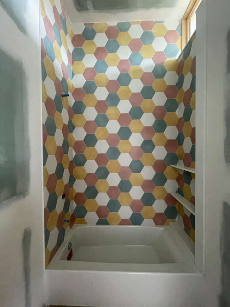 Tile installation at Artists' Ranch continues to make progress, with colorful tile selections in one of the kid's bathrooms.