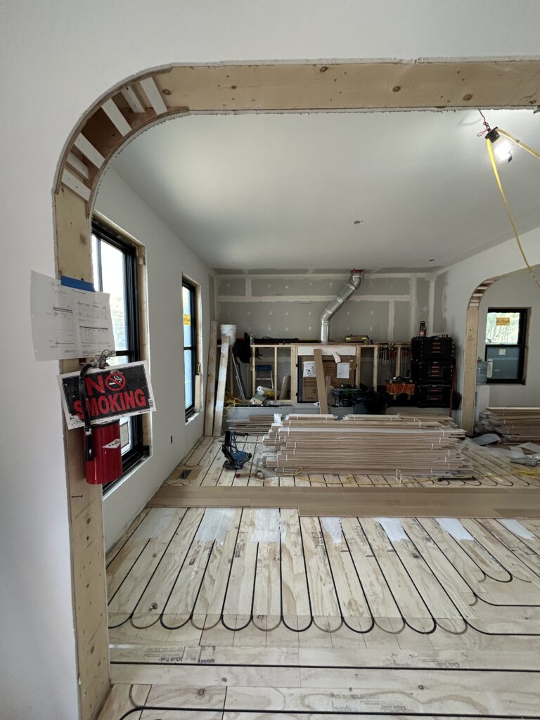 Completed drywall at Hudson House townhouse renovation, with smooth walls and ceilings ready for millwork installation and final finishes.