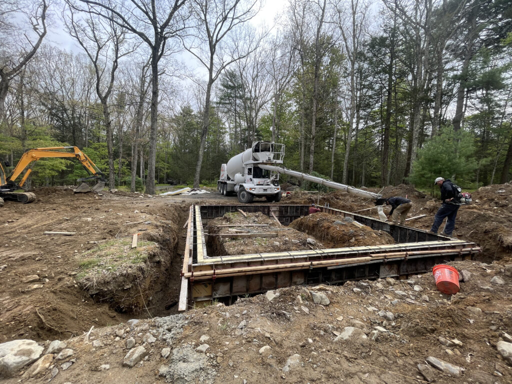 Freshly poured concrete footings and foundation at the Gallery at Cluster One, marking the beginning of structural construction.