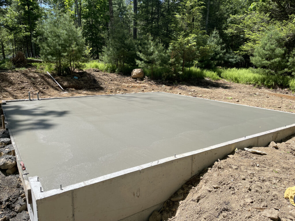 Concrete slab pour in progress at the Gallery at Cluster One, with formwork and reinforcement visible across the foundation.