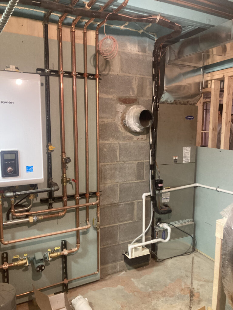 Rhinecliff Guesthouse basement renovation in progress, showing new ductwork and HVAC systems that have opened up the ceiling height and overall space.
