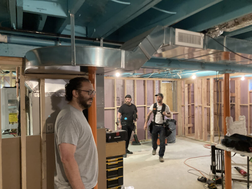 Interior view of Rhinecliff Guesthouse basement transformation, with new mechanical systems installed and walls prepared for finishing.