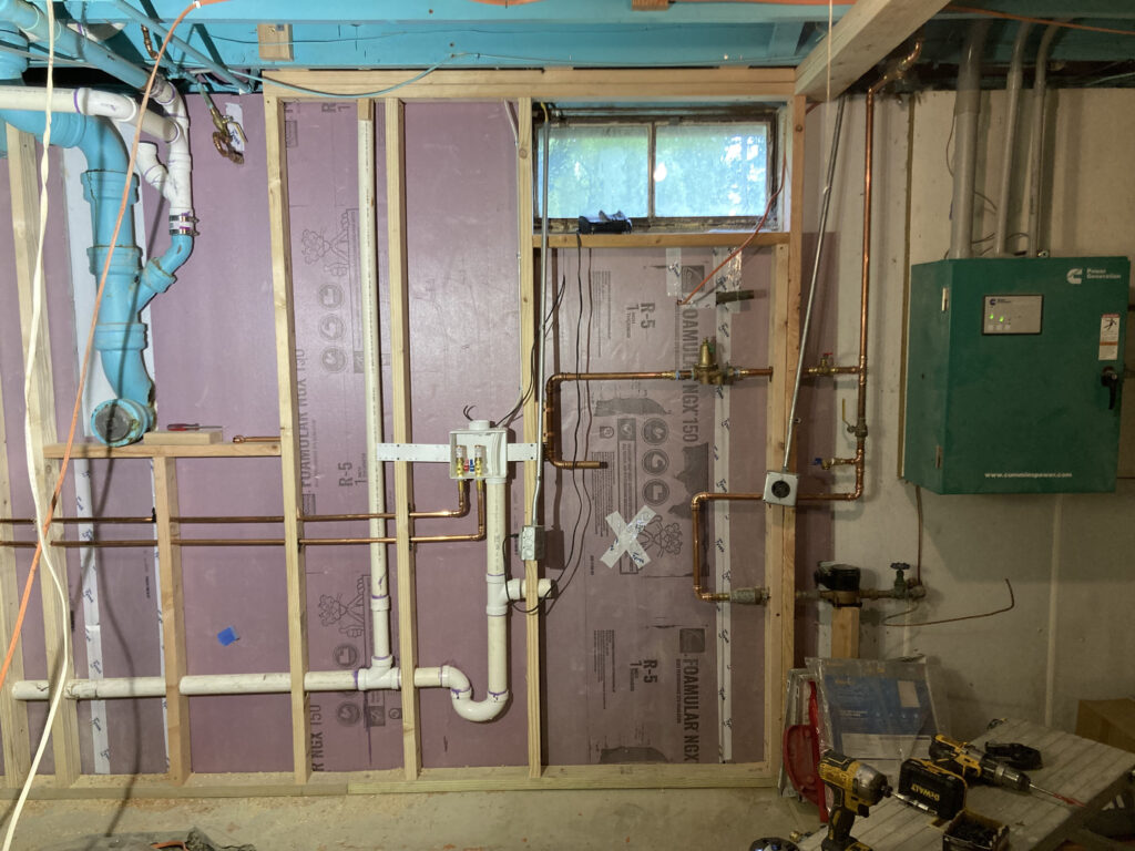 Detail view of new mechanical and ductwork installation at Rhinecliff Guesthouse, demonstrating clean and precise construction work during basement renovation.