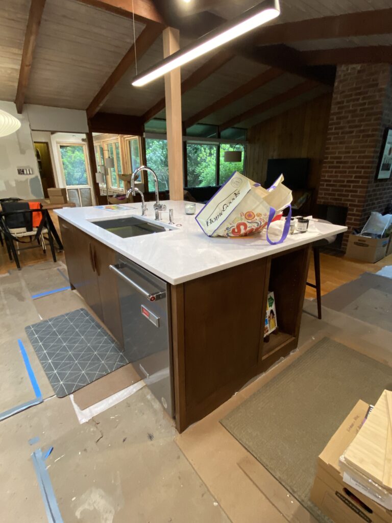 Appliances and countertops installed at MCM Reno kitchen, showing the space nearly complete with a clean, modern aesthetic.