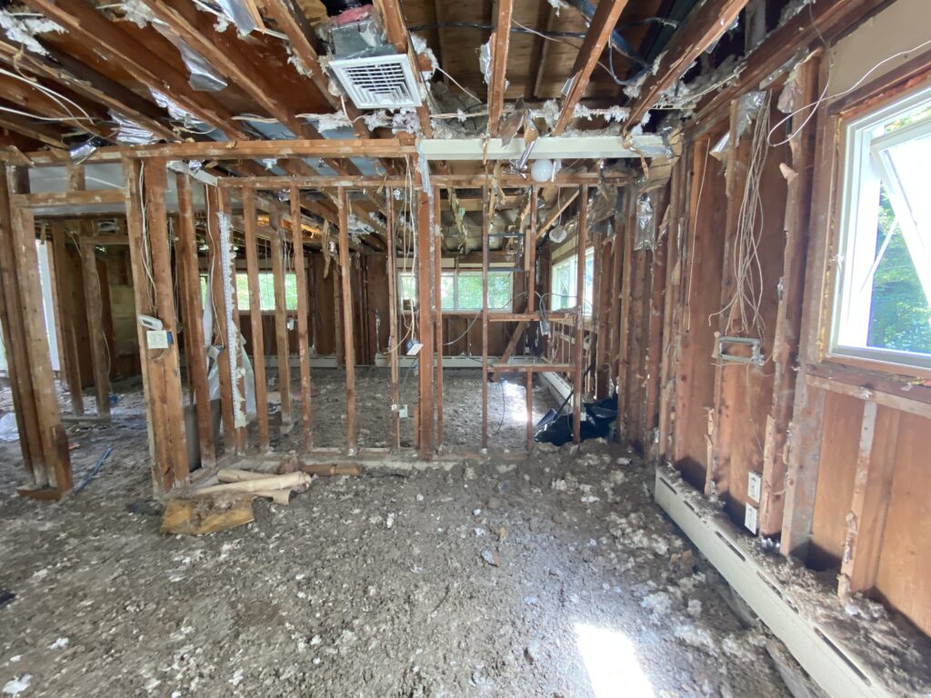 Interior demolition at MCM32 with concrete slab fully removed, revealing the scope of foundation and framing work ahead.