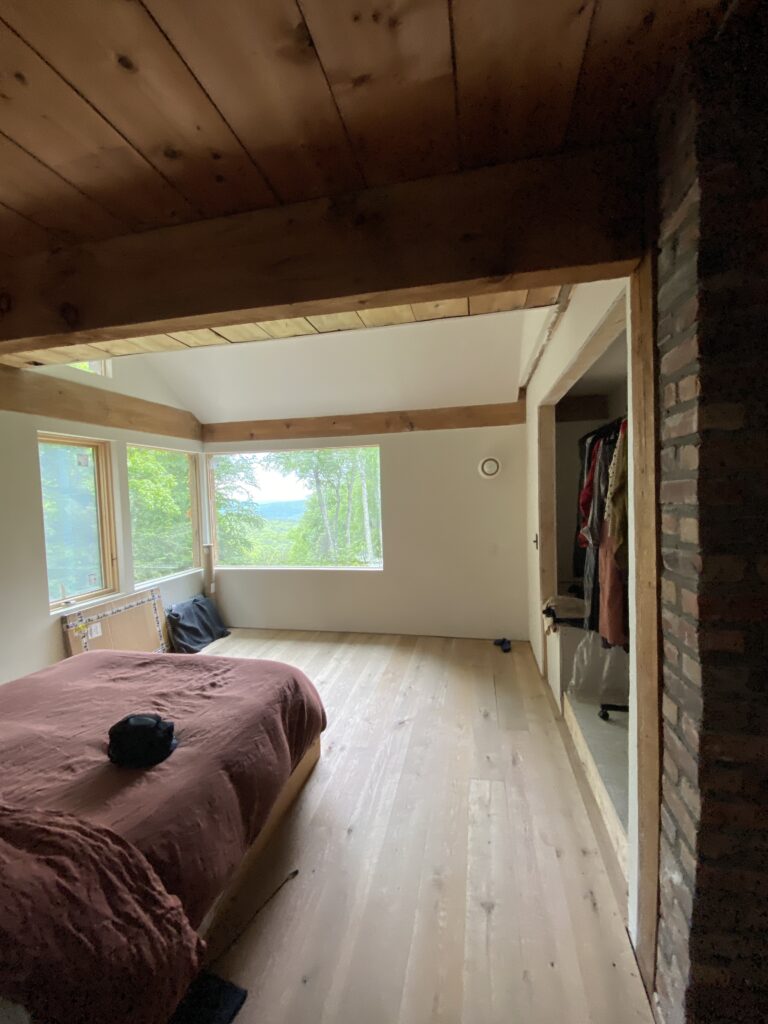 Wood flooring installation complete on the upper level of Mt Tremper Cottage, with warm tones complementing the cottage's natural character.
