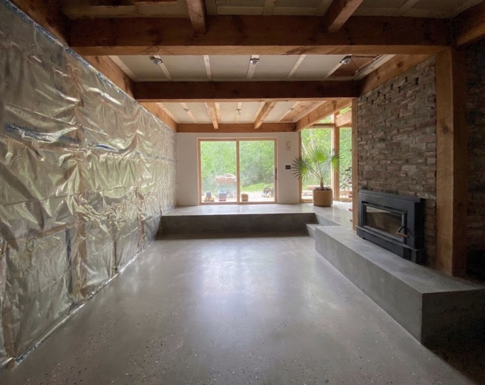 Sunken living room at Mount Tremper Cottage, which includes a freshly poured concrete slab.