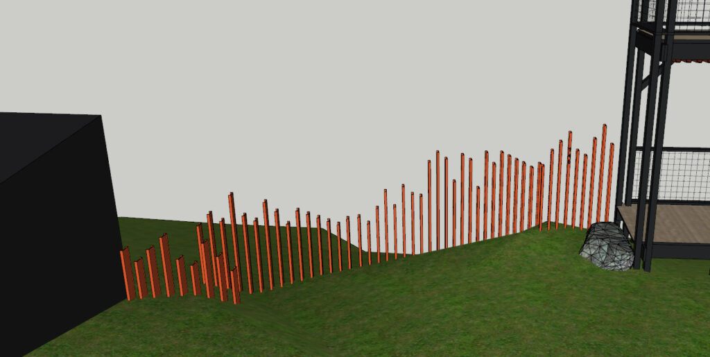 Freshly installed orange steel fence posts against a wooded Hudson Valley backdrop
