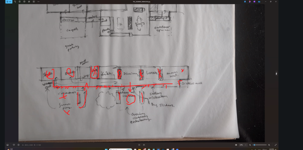 Hand-drawn floor plan sketch of a linear room sequence with red-marker notes on views, gallery clerestories, and big sliding doors